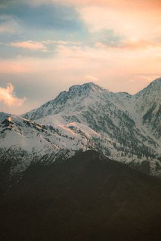 Breathtaking view of snowy mountains in Anantnag basking in the warm glow of sunrise.