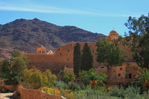 Free St. Catherine's Monastery, surrounded by Sinai mountains, under clear sky. Stock Photo