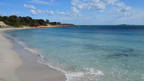 Free Capture of a scenic beach in Porto-Vecchio, Corsica with crystal clear waters and a clear blue sky. Stock Photo