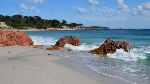 Free Explore the striking red rocks and clear waters on this picturesque beach in Porto-Vecchio, Corsica, France. Stock Photo