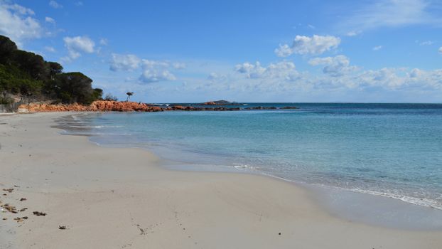 Relaxing coastal scene with turquoise waters and blue skies in Porto-Vecchio, Corsica, France.