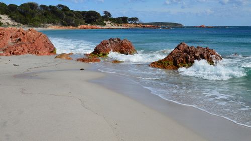Free Stunning coastal view of red rocks and turquoise sea in Porto-Vecchio, Corsica, France. Stock Photo