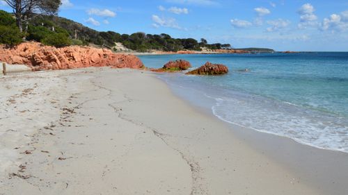 Free Discover the scenic beauty of Porto-Vecchio's coastline with crystal-clear waters and red rocks. Stock Photo