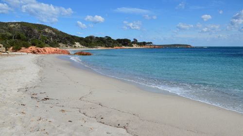 Free A serene and sandy beach with turquoise waters in Porto-Vecchio, Corsica, France. Stock Photo