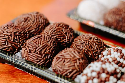 Close-up of delicious chocolate brigadeiros adorned with sprinkles, perfect for celebrations and parties.