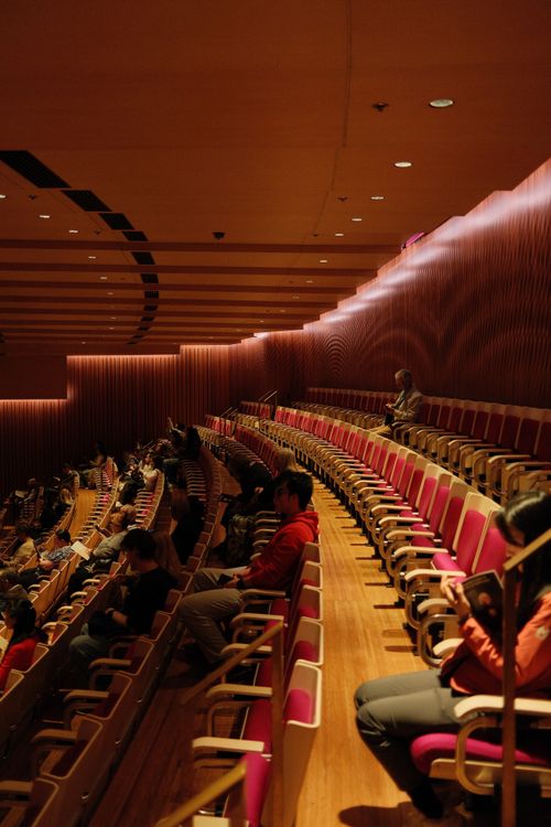 Free Audience in Sydney Opera House auditorium watching a performance, showcasing modern interior design. Stock Photo