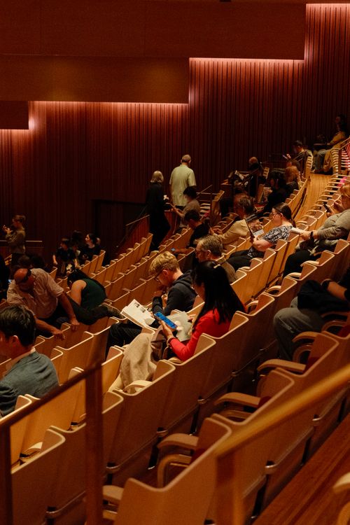 Free Audience gathers in Sydney concert hall, seated before the show starts. Stock Photo