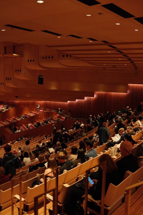 Free Audience seated in Sydney Opera House's iconic concert hall for a live performance. Stock Photo