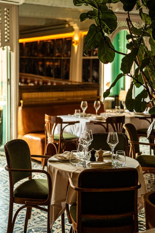 Free Warm and inviting restaurant interior with set tables and elegant decor, perfect for fine dining experiences. Stock Photo