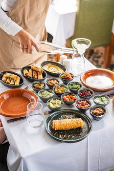 A vibrant selection of Mediterranean dishes served on a table indoors.