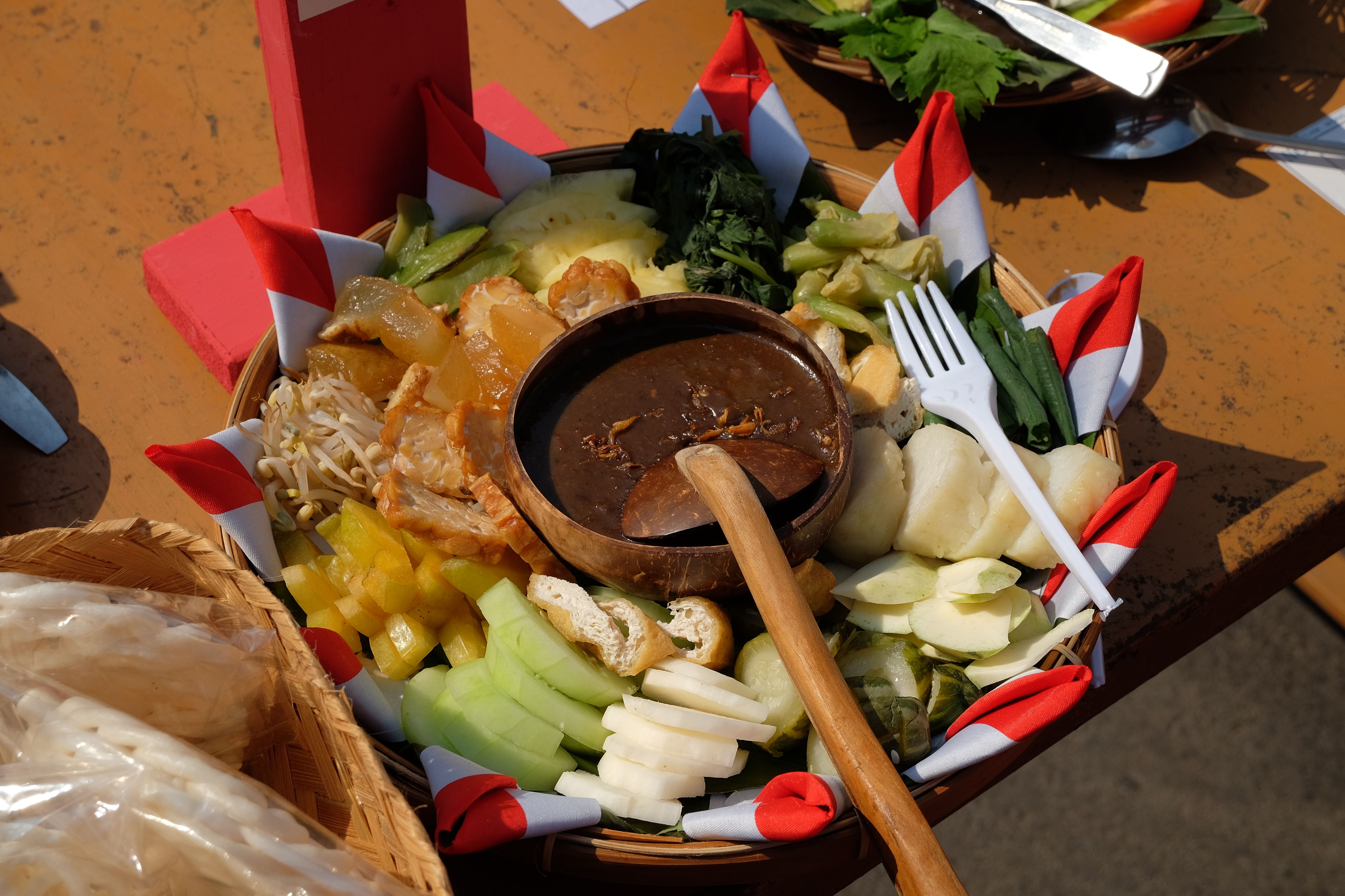 Delicious Indonesian traditional salad with peanut sauce captured in vibrant colors outdoors.