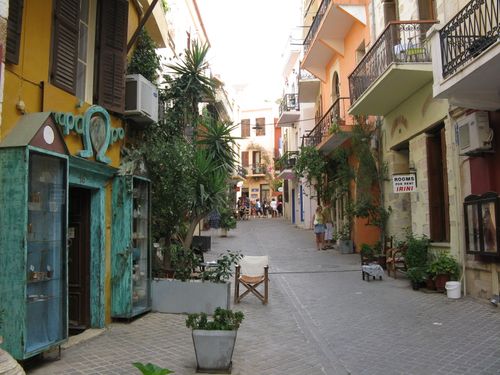 Free A picturesque alleyway lined with colorful buildings and lush greenery in a Mediterranean town. Stock Photo