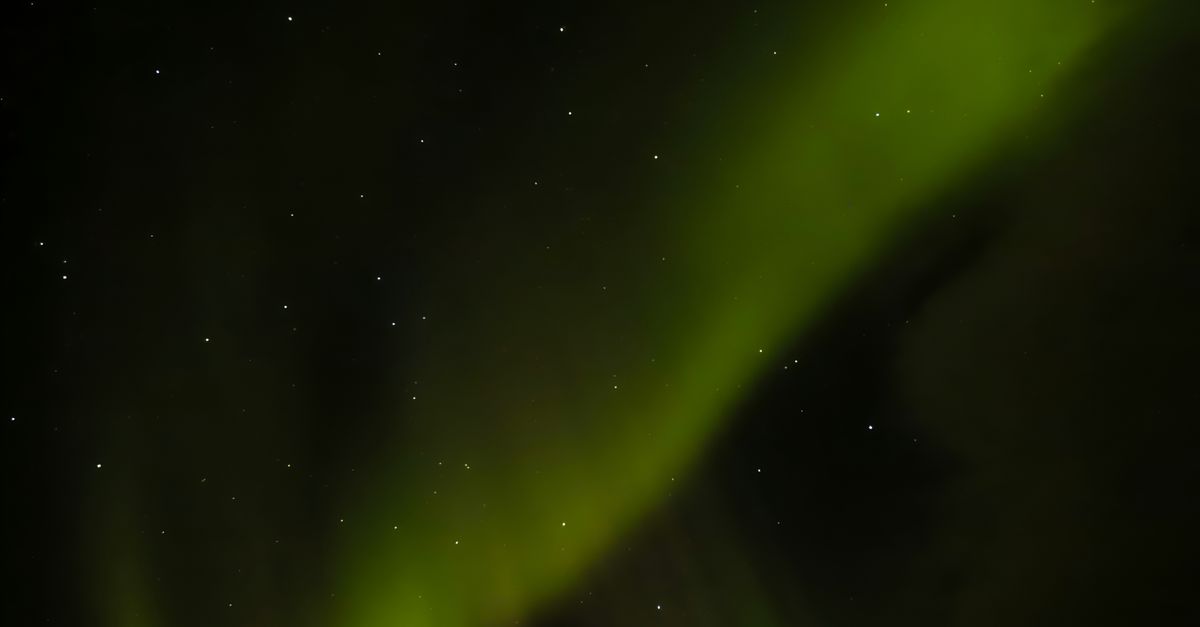 Stunning view of the Northern Lights with stars illuminating the night sky.