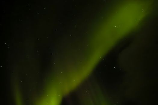 Stunning view of the Northern Lights with stars illuminating the night sky.