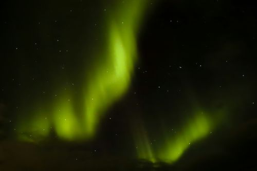 Free Captivating display of the Northern Lights glowing vividly in the night sky. Stock Photo