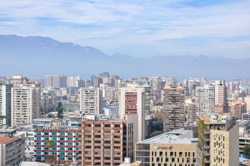 Free Stunning aerial view of Santiago, Chile, showcasing modern skyscrapers with mountain backdrop. Stock Photo