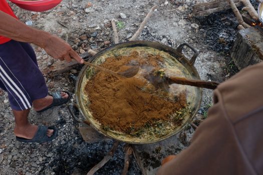 Experience a rustic cooking method in Gresik, Indonesia, capturing local culinary practices and techniques.