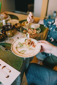 Cozy indoor setting with people enjoying a traditional Jewish meal with wine and tableware.