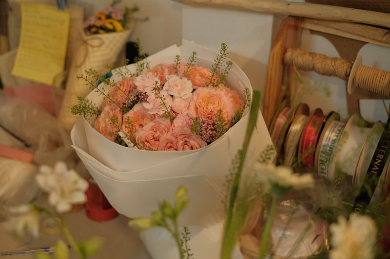 Elegant seasonal bouquet wrapped with ribbon by Bloom & Wild Florals in Charleston, South Carolina
