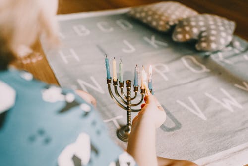 Person Lighting Menorah