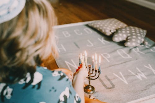 Boy Lighting Menorah