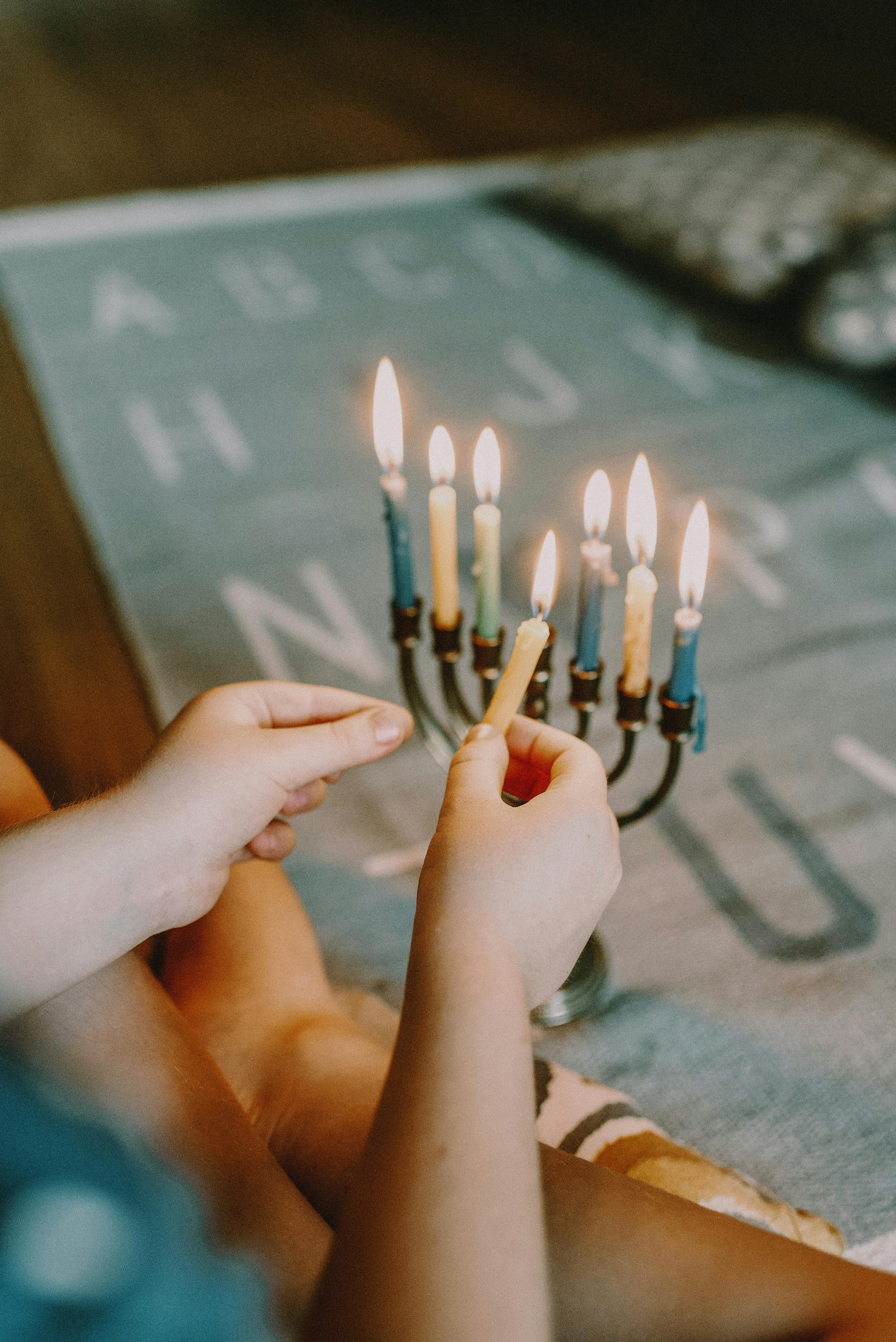 Person Lighting Menorah · Free Stock Photo
