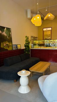 Warm and inviting modern cafe with seating area, lighting, and decor.