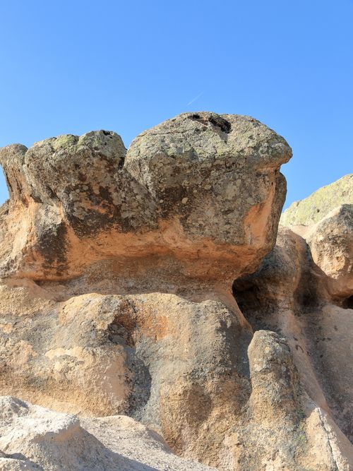 Free Close-up of a natural rock formation against a clear blue sky, showcasing its unique textures. Stock Photo