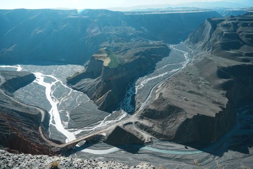 Free Striking aerial shot of the intricate river weaving through the Grand Canyon's dramatic ravines. Stock Photo