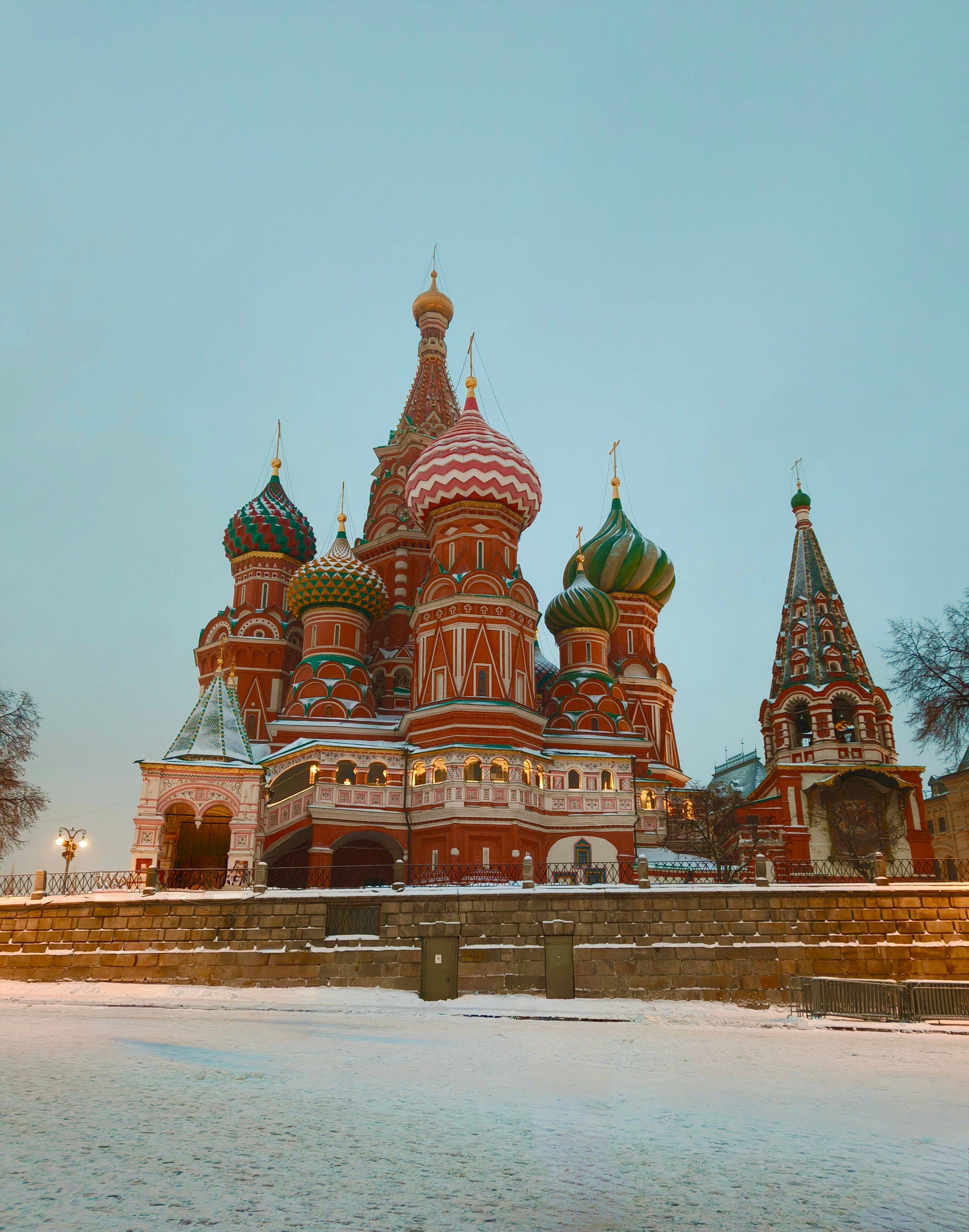 Winter view of St. Basil's Cathedral, Moscow, showcasing its colorful domes and snow-covered surroundings.