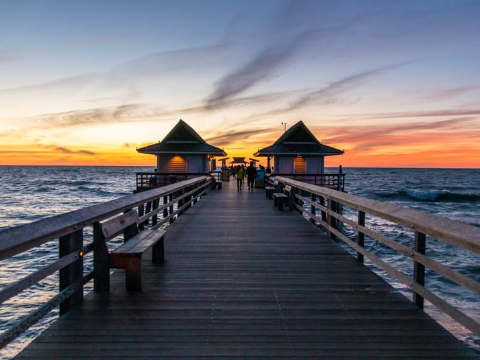 Captivating sunset view from Naples Pier, Florida; a serene ocean landscape.