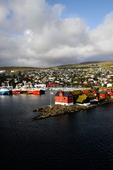 A stunning aerial view of Torshavn, featuring colorful buildings, boats, and the scenic port.