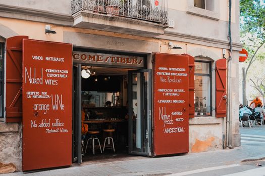 Exterior view of a quaint wine bar in Spain, showcasing its rustic charm and inviting atmosphere.