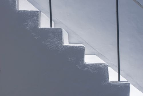 Free Artistic shot of white stairs with elegant shadows and natural light creating a minimalist look. Stock Photo