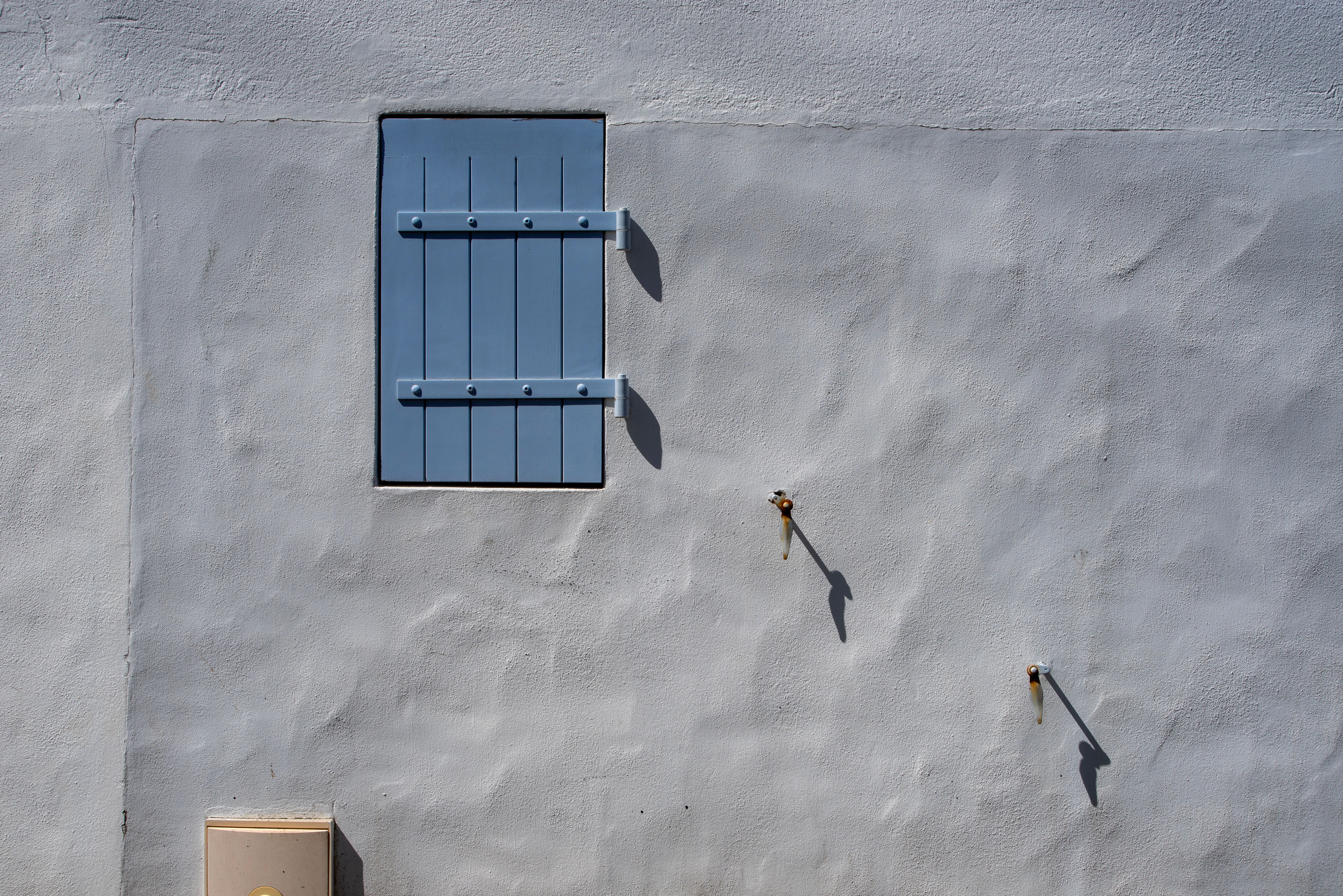 Minimal blue window on a plastered wall