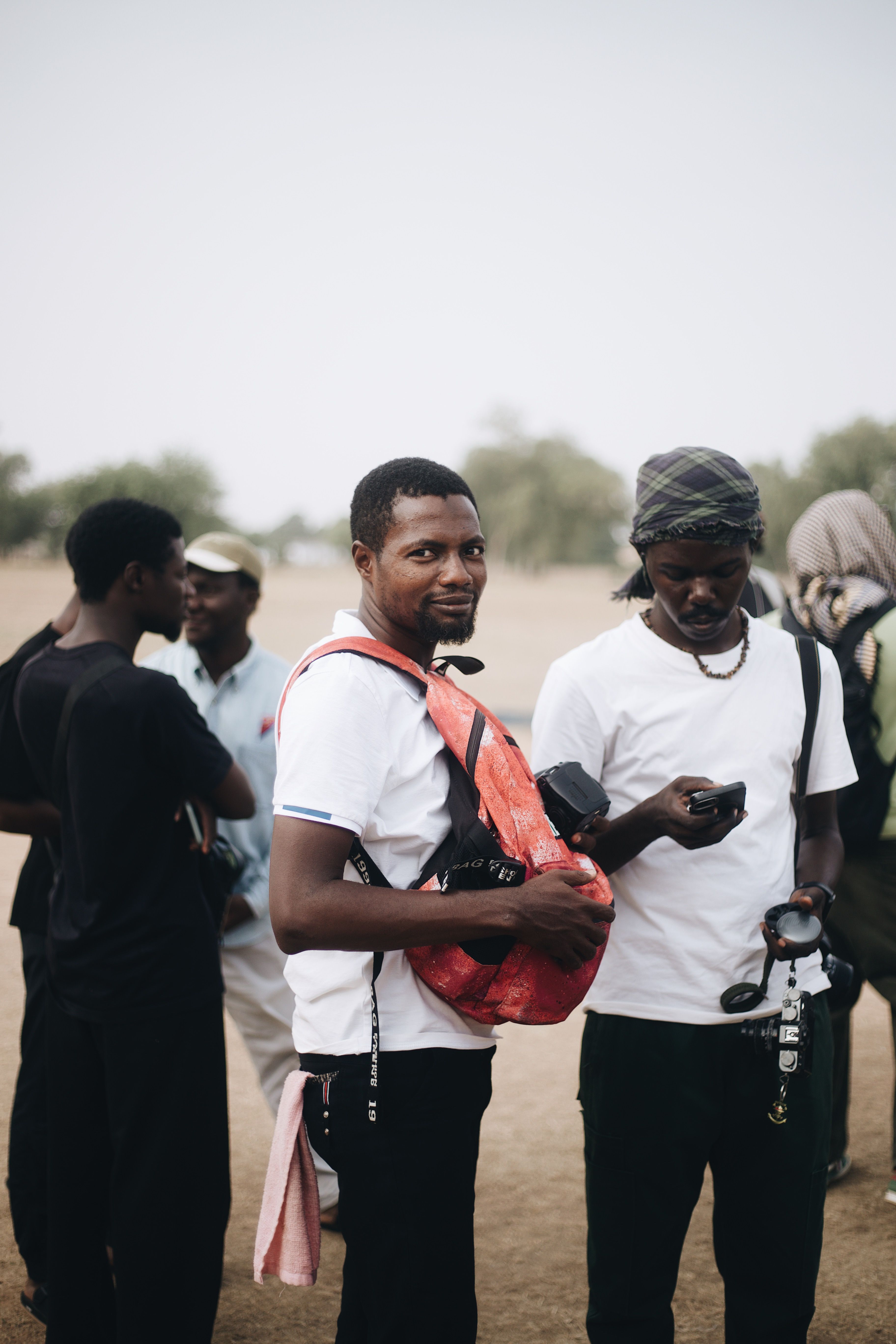 Group of Men Socializing Outdoors in Nigeria · Free Stock Photo