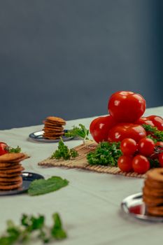 A vibrant display of tomatoes with fresh herbs in an indoor setting.