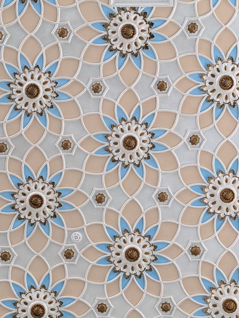 Detailed floral and geometric design featuring blue, beige, and white patterns.