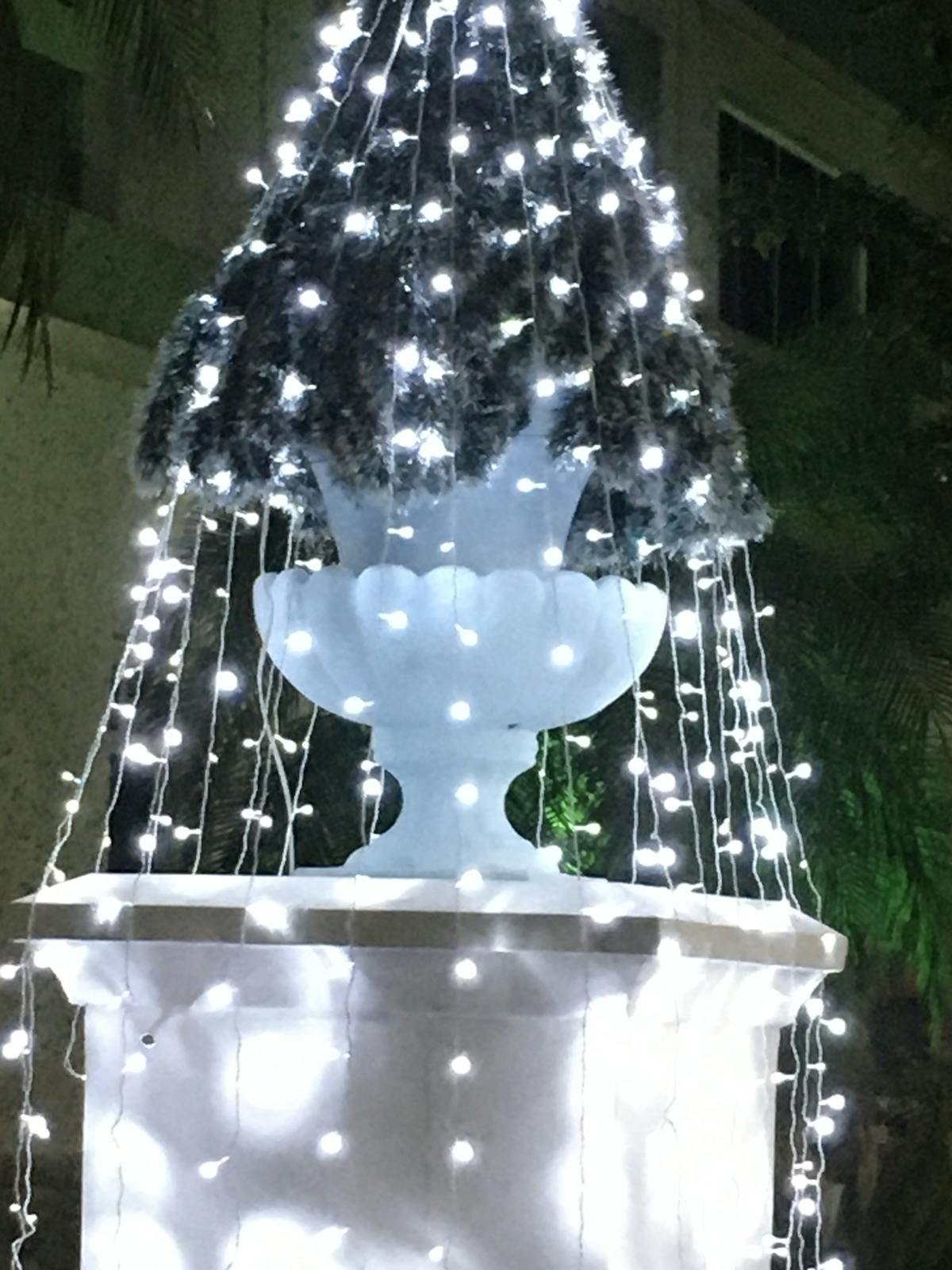 A bowl of creamy yogurt sauce with herbs and lemon