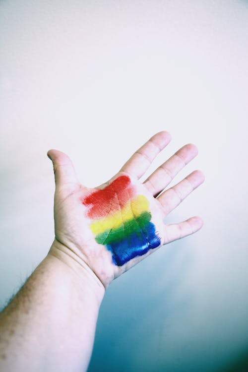 Free Photo of Person's Hand With Rainbow Colors Stock Photo