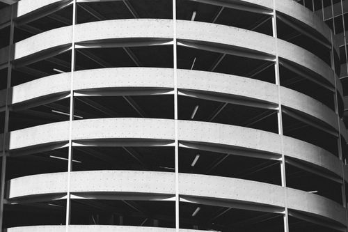 Free Black and white photo of a circular parking garage with curved lines and light contrasts. Stock Photo