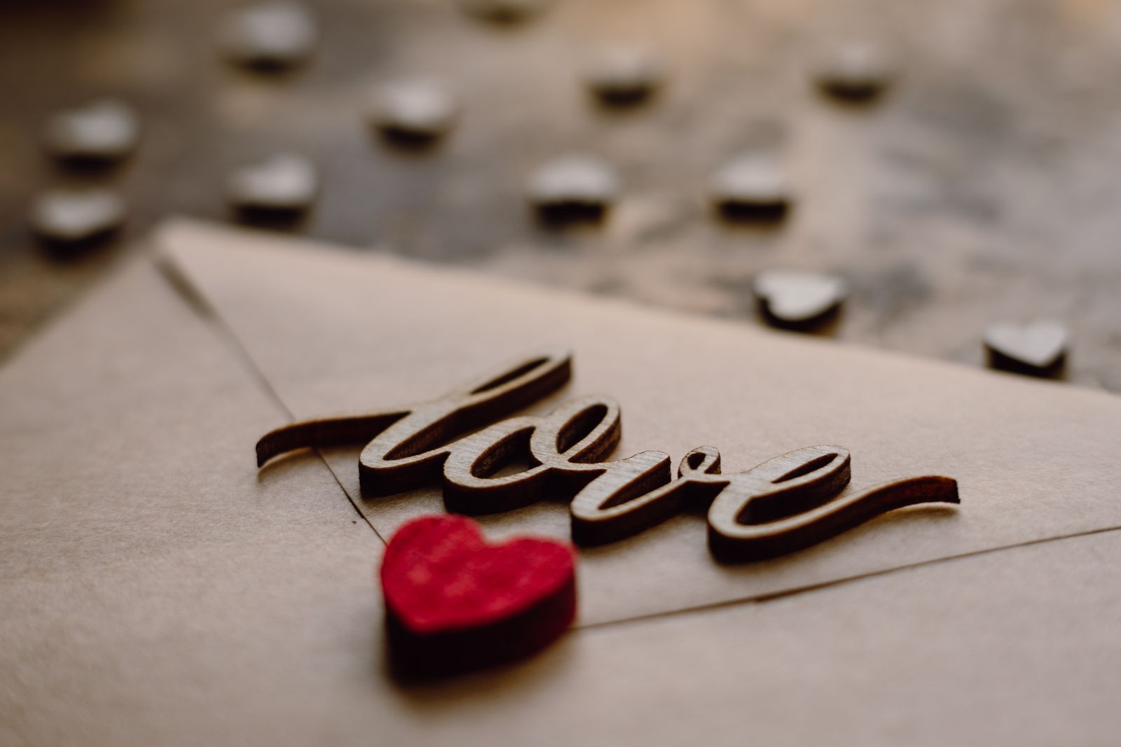 A card with the word love and a red heart