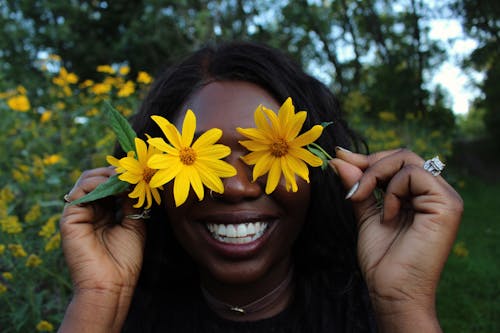афро американская женщина с цветами в парке
