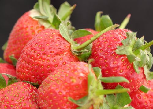 Free A close-up view of fresh, ripe strawberries showcasing their vibrant red color and texture. Stock Photo