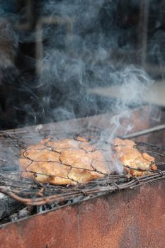 Authentic Indonesian grilled chicken sizzling over an open flame, with rich smoky flavors.