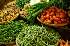 Colorful assortment of fresh vegetables in a local market setting.