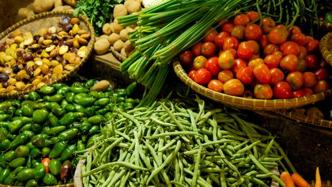 Colorful assortment of fresh vegetables in a local market setting.