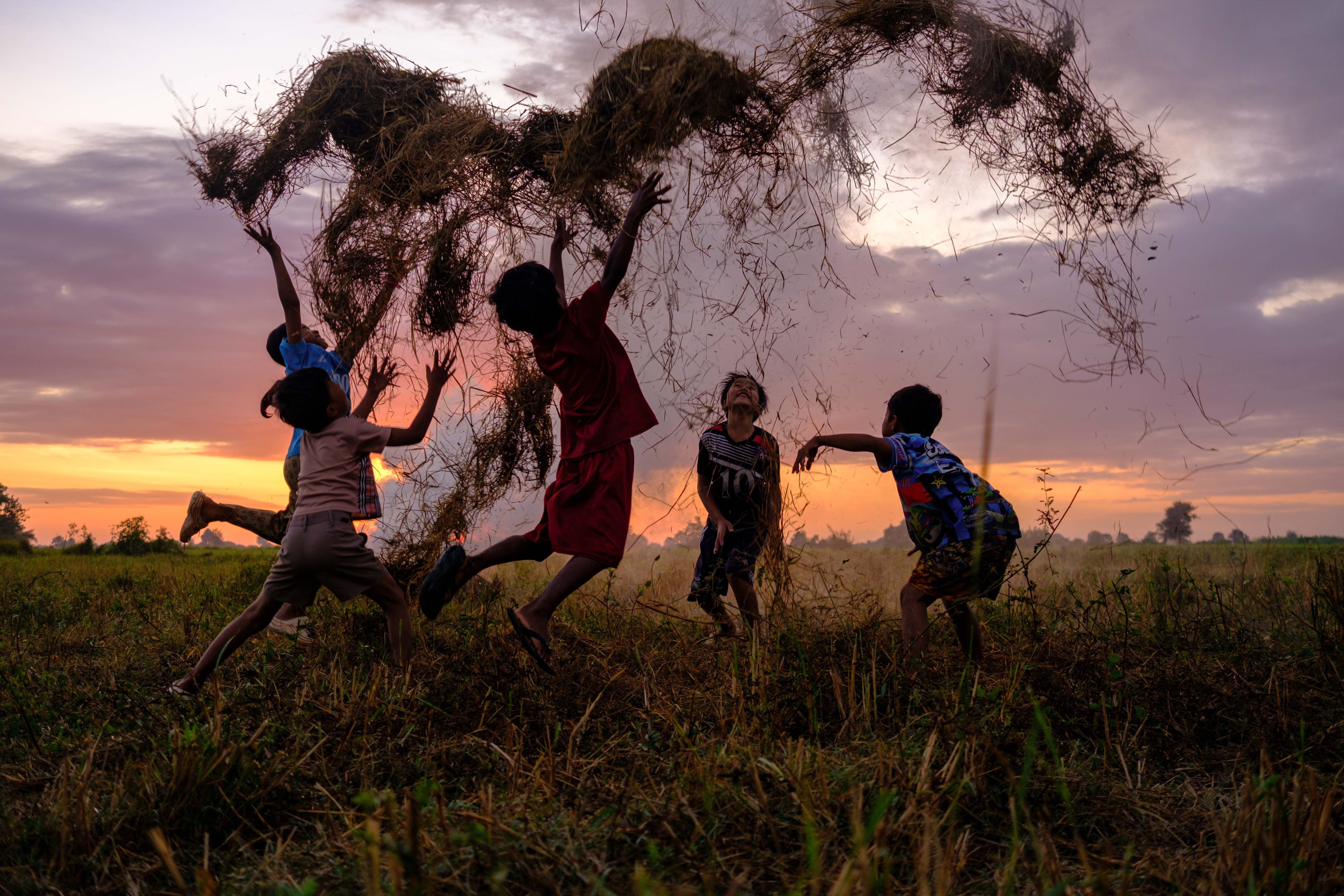 Children Playing in Cambodian Sunset Field · Free Stock Photo