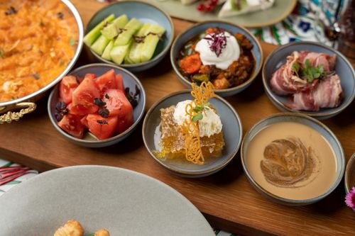 Free Delicious assortment of appetizers including fresh vegetables, meats, and dessert served on a wooden platter. Stock Photo