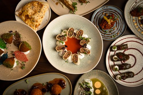 Free A captivating assortment of gourmet dishes elegantly presented on modern plates, showcasing diverse culinary artistry. Stock Photo